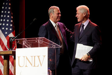 Former President Bill Clinton is welcomed to the podium by Brian Greenspun. (Aaron Mayes/UNLV Photo Services)