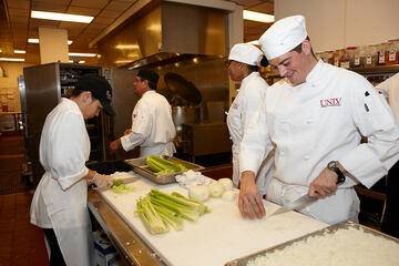 Students of the William F. Harrah College of Hotel Administration students practice their craft in Bellagio’s kitchen under the direction of guest chef Alex Stratta and Bellagio chef Jason Johnston. (Geri Kodey/UNLV Photo Services)