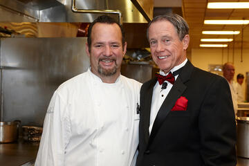 UNLV Foundation Chairman John O’Reilly stops by the Bellagio kitchen to thank guest chef Alex Stratta. (Geri Kodey/UNLV Photo Services)