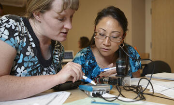 Two female researchers reviewing the results of their testing.