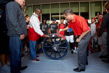 UNLV President Len Jessup gets in on the painting action.