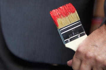 A paintbrush with wet fresh paint about to be used.