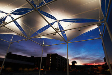 Outside sun covers behind the Student Union during the evening.