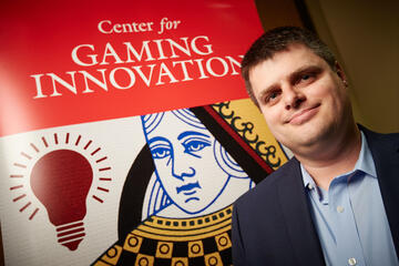 Daniel Sahl in front of a Gaming Innovation Banner 