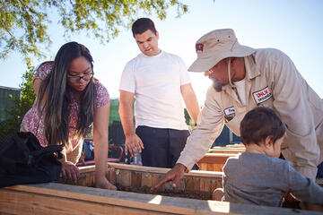 Antonio Duron, with UNLV grounds takes care of his planters with his family. (Josh Hawkins/UNLV Creative Services)