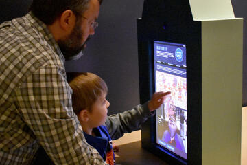 child interacting with touchscreen interface