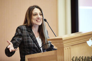 Marta Soligo speaking at a podium