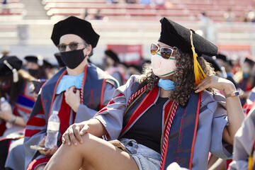 graduate seated wearing regalia
