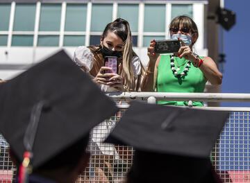 family taking pictures of graduates