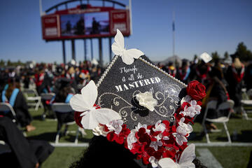 Grad caps decorated with illustrative messages
