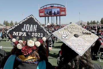 Grad caps decorated with illustrative messages