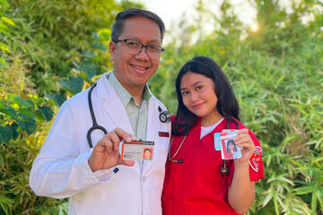 A father and daughter stand together