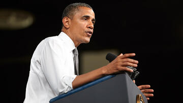 Left side view of President Obama as he stands at a podium and delivers a speech.