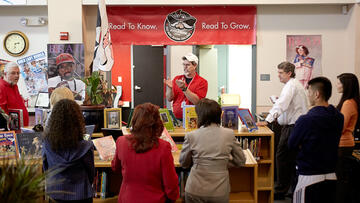 Group of people standing and discussing.