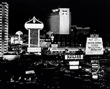 View of the Las Vegas Strip at night. Showing the MGM Grand, Flamingo Hilton, the Dunes Hotel and Casino, and Barbary Coast.