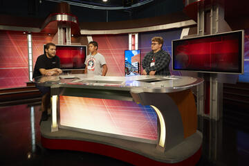 three students in TV studio