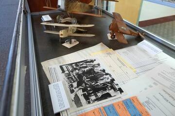 Miniature airplanes, photographs, and documents on display as part of the "Script to Screen" exhibit in Lied Library.
