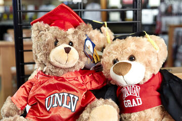 two stuffed teddy bears wearing UNLV shirts