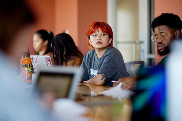 red-headed student observes during lecture