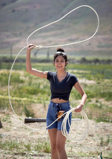 Woman swinging lasso.