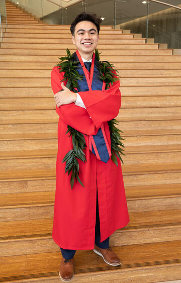 student in red graduation robe