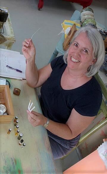 smiling woman working with essential oils