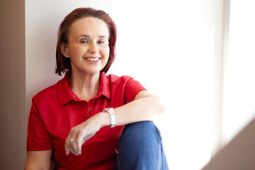woman posing in red shirt