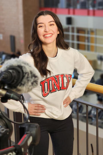 woman in UNLV sweatshirt in front of tv camera