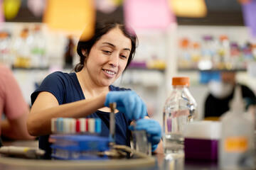 female student working with science lab equipment