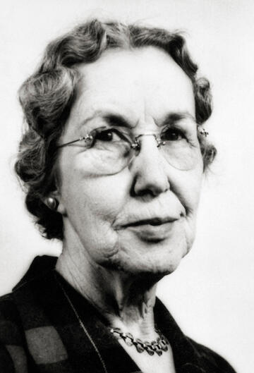 black and white portrait of older woman with glasses