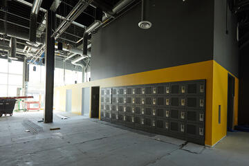 lockers line wall of large open room under construction