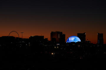 The MSG Sphere displays an image of a basketball emblazoned with an NBA Summer League logo lighting up the Las Vegas skyline at dusk