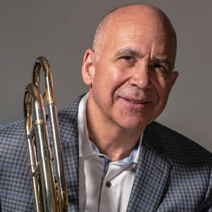 cropped image of man holding a trombone