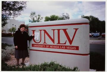 woman next to sign that reads UNLV