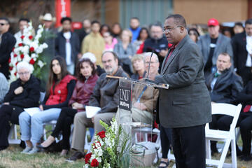 man speaking at memorial vigil