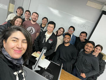 group photo of students with professor in classroom