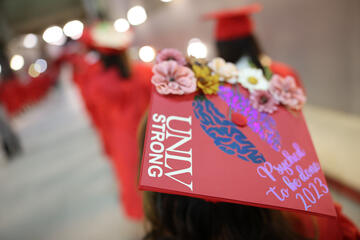 commencement cap decorated with UNLV Strong message and flowers