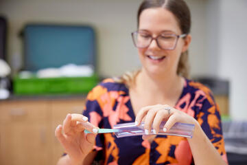 woman practicing a science project during a training program