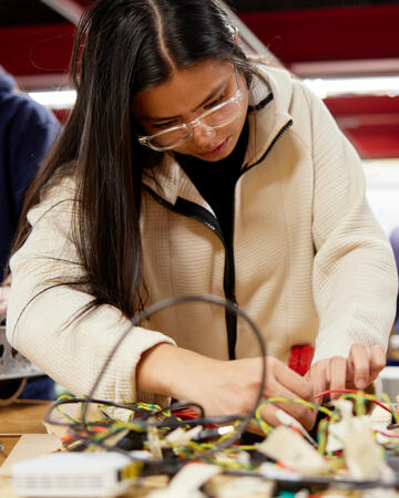 A UNLV student working on a robot.