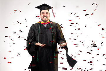 Victor Aldana wears a black cap and gown