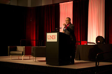 UNLV President Keith Whitfield speaking at podium during summit