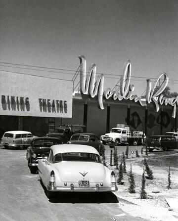 black and white photo of the Moulin Rouge hotel's exterior and sign