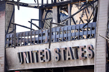 close up of United States Postal Office sign after fire