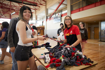 two students helping to create dog toys