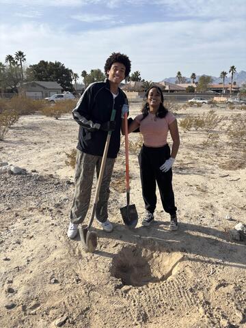 male and female club members dig holes for owls