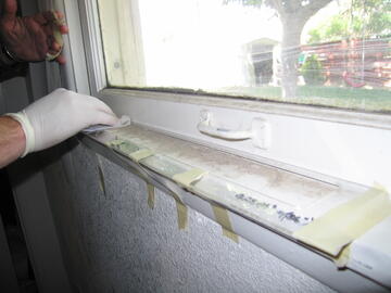 window sill showing lead from dust and chipped white paint