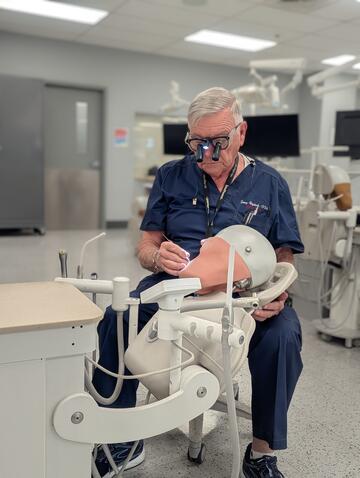 Dr. Raybeck demonstrating dental equipment