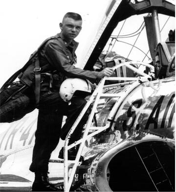 black and white photo of Dr. Raybeck getting into a plane