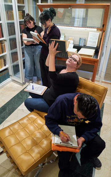 Students examine rare books in Beverly Rogers private collection. 