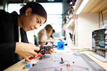 Mechanical engineering Carol Daguer works on building her prototype in the Maker Space.